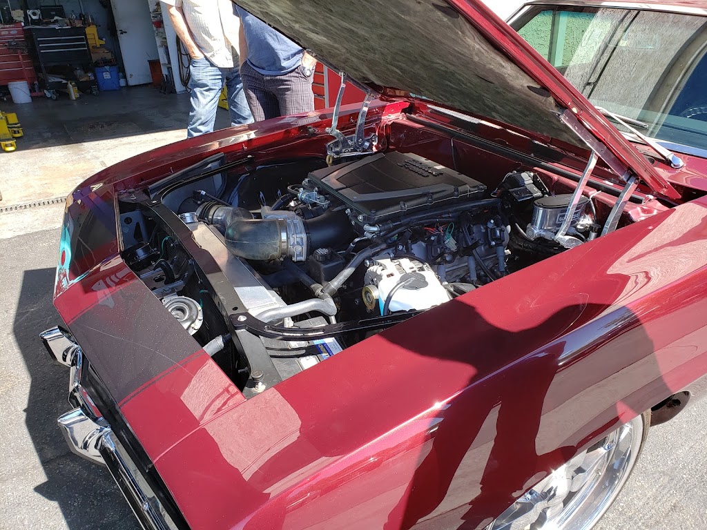Classic car engine bay being serviced at American Auto Repair and A/C